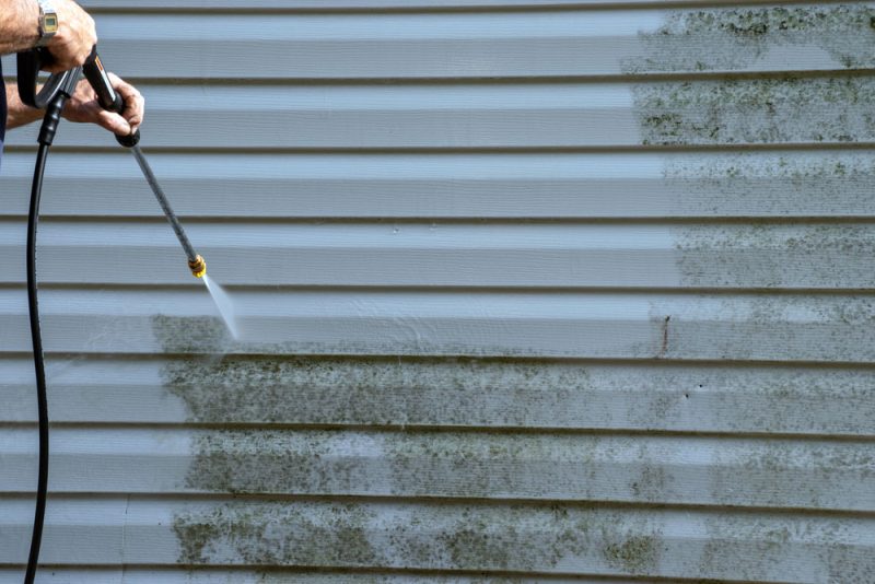 home siding maintenance with power washer